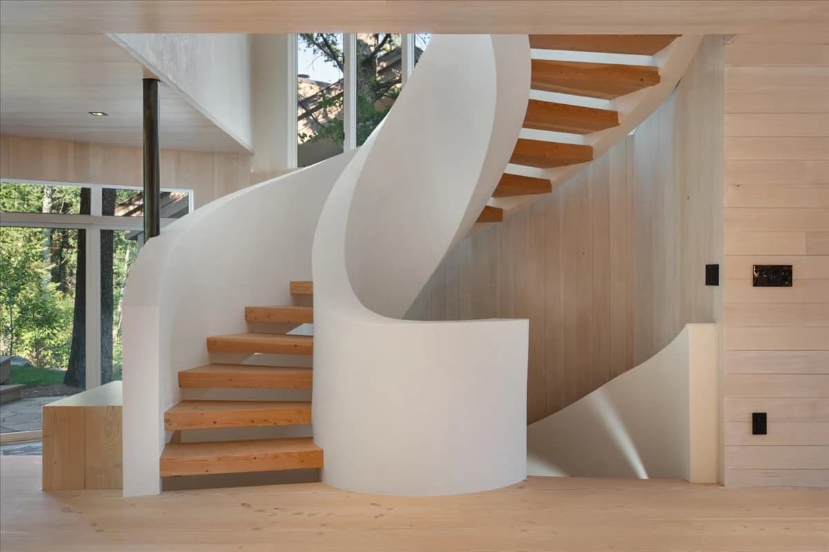 Sculptural white spiral staircase with wood treads