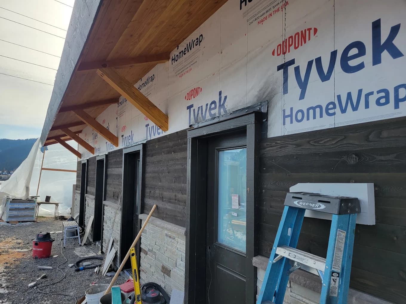 Construction site with house wrap and framed door openings