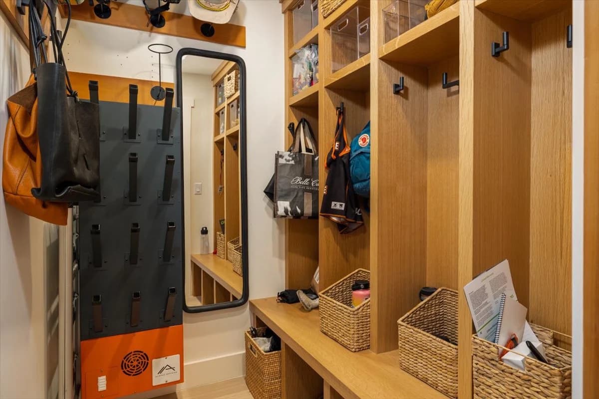 Custom mudroom with built-in lockers and woven storage baskets